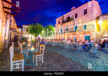 Night view of the traditional village of Areopoli in Mani region with the picturesque alleys and the stone built tower houses,  Peloponnese, Greece Stock Photo