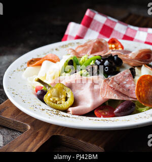 Antipasto platter with marinated vegetables, olives, cheeses and cured meats Stock Photo