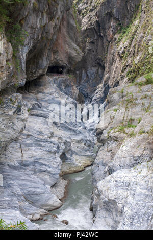 Cliffside tunnel's galleries and stream flowing through marble canyons, Tunnel of Nine Turns, Taroko National Park, Hualien, Taiwan Stock Photo