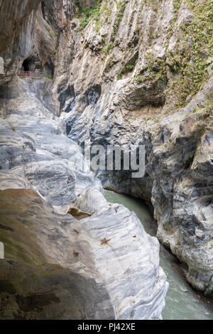 Cliffside tunnel's galleries and stream flowing through marble canyons, Tunnel of Nine Turns, Taroko National Park, Hualien, Taiwan Stock Photo