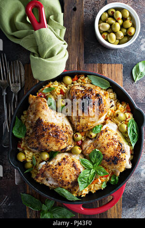 Roasted chicken thighs with spanish rice and olives Stock Photo