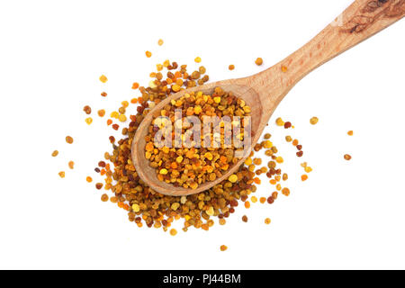 fresh bee pollen in wooden spoon isolated on white background. Top view. Flat lay Stock Photo