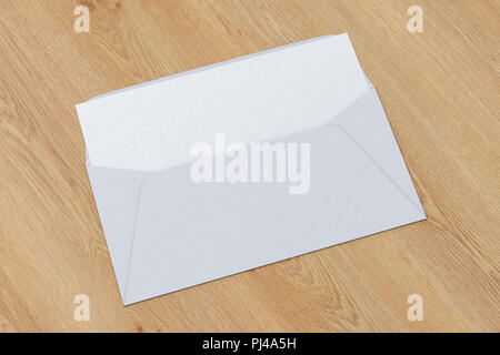 White blank envelope with blank letter inside on wooden background. 3d render Stock Photo