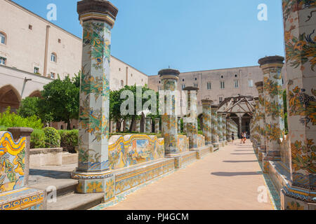 NAPLES, ITALY - AUGUST 1, 2018: Sunny cloister of the Clarisses decorated with majolica tiles from Santa Chiara Monastery in Naples, Italy. Stock Photo