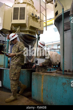 249th Engineer Battalion (Prime Power) is a U.S. Army unit specializing in power engineering. The archival photographic print documents personnel inspecting water pumps inside La Plata Lake Dam, Toa Alta, Puerto Rico, in August 2018 to assess electrical requirements during post-Hurricane Maria recovery. The historical record highlights technical evaluation and power infrastructure assessment. Stock Photo