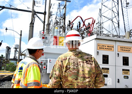 249th Engineer Battalion (Prime Power) is a U.S. Army unit specializing in power engineering and electrical support. The archival photographic print records personnel discussing operations at a power sub-station serving La Plata Lake Dam, Toa Alta, Puerto Rico, in August 2018 during Hurricane Maria recovery efforts. The historical image documents technical evaluation and coordination with local utility authorities. Stock Photo
