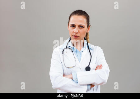 Angry female doctor looking away and thinking about something. Stock Photo