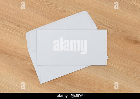 Blank letter on white blank envelope on wooden background. 3d render Stock Photo