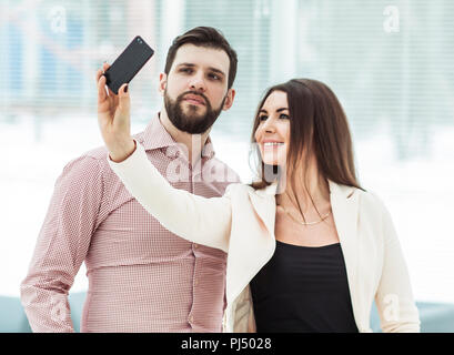 company's employees make selfie while standing near window in office Stock Photo