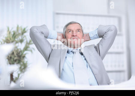 senior businessman dreaming of sitting at his Desk Stock Photo