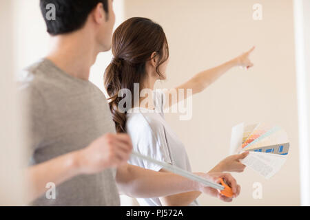 Young couple working on home renovation Stock Photo