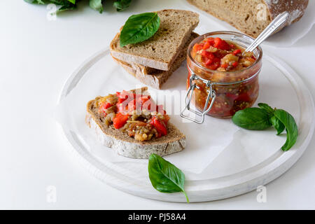 Rye bread toasts and glass jar with eggplant caviar. Vegetable appetizer or antipasti. Healthy food concept Stock Photo