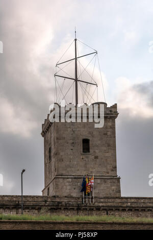 Turret of Montjuic Castle against cloudy sky. Montjuic Castle is an old military fortress, built on top of Montjuic hill. Now it serves as a municipal Stock Photo