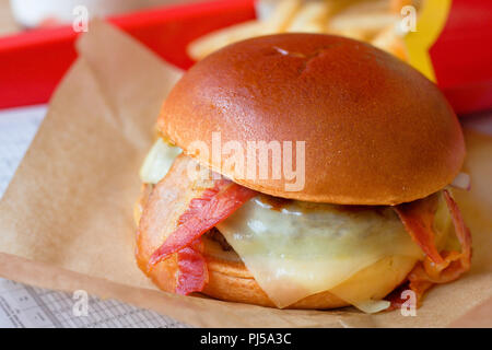 Hamburger sandwich and fries in fast food restaurant Stock Photo