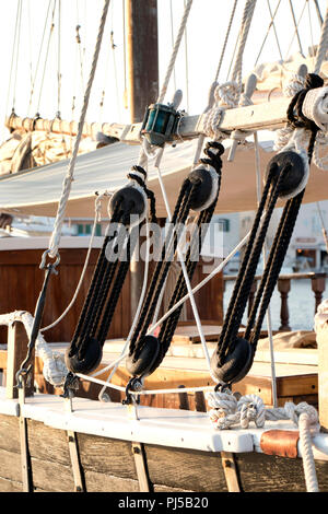 Detail of vintage sailboat wooden rigging and white and black ropes Stock Photo