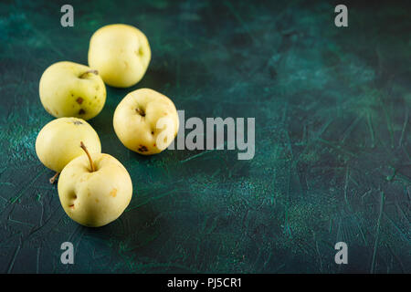 Fresh green apples on dark green background Stock Photo