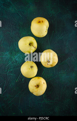 Fresh green apples on dark green background Stock Photo