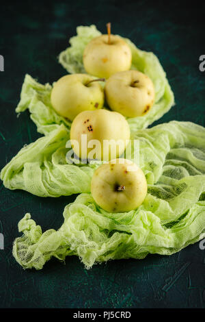 Fresh green apples on dark green background Stock Photo