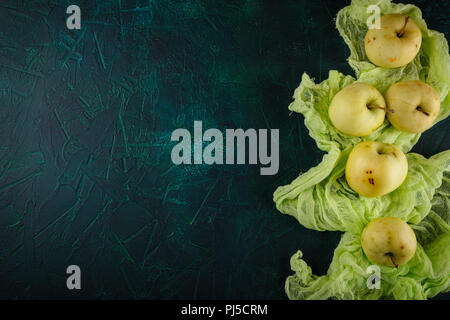 Fresh green apples on dark green background Stock Photo