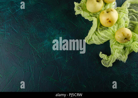 Fresh green apples on dark green background Stock Photo