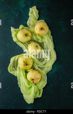 Fresh green apples on dark green background Stock Photo