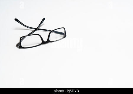 a pair of glasses on a white surface Stock Photo