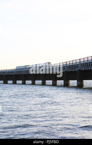 A train crossing the Tay Rail Bridge, over the Estuary between the City of Dundee and Fife, in Scotland, UK Stock Photo