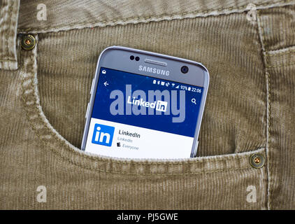 MONTREAL, CANADA - AUGUST 10, 2018: Linkedin app on a cellphone screen in a jeans pocket. LinkedIn is a social networking site designed specifically f Stock Photo