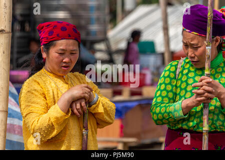 Dong Van, Vietnam - March 18, 2018: Mong ethnic minority women with colorful dresses at Dong Van sunday market Stock Photo