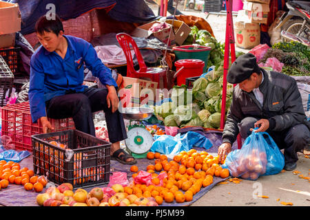Dong Van, Vietnam - March 18, 2018: People buying and selling fruits and vegetables at Dong Van sunday market Stock Photo