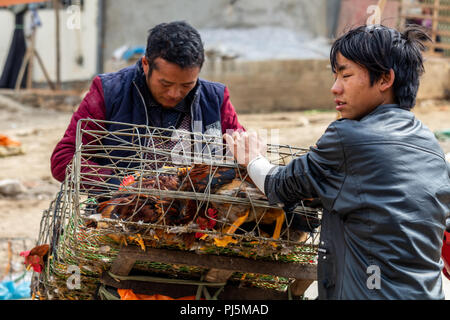 Dong Van, Vietnam - March 18, 2018: People from Hmong ethnic minority selling chicken at the Dong Van sunday market Stock Photo