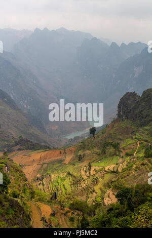 Ha Giang, Vietnam - March 18, 2018: Rice terraces, mountains and lake seen from Ma Pi Leng peak Stock Photo