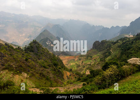 Ha Giang, Vietnam - March 18, 2018: Rice terraces, mountains and lake seen from Ma Pi Leng peak Stock Photo