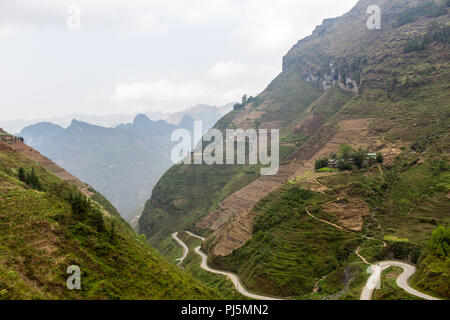 Ha Giang, Vietnam - March 18, 2018: Stunning view of terraced land and high mountains at Ma Pi Leng pass, one of the most dangerous roads of Vietnam Stock Photo