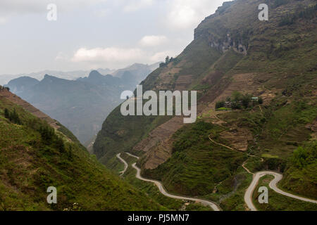 Ha Giang, Vietnam - March 18, 2018: Stunning view of terraced land and high mountains at Ma Pi Leng pass, one of the most dangerous roads of Vietnam Stock Photo