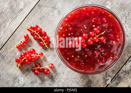 Cranberry sauce in bowl for Thanksgiving dinner on wooden table. Top view Stock Photo