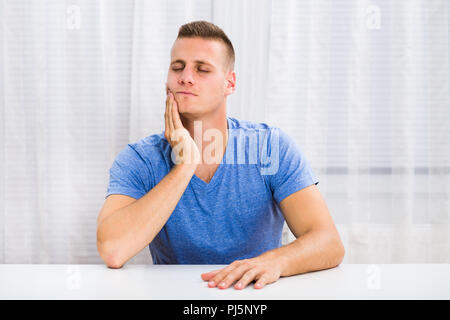 Young man is having toothache. Stock Photo