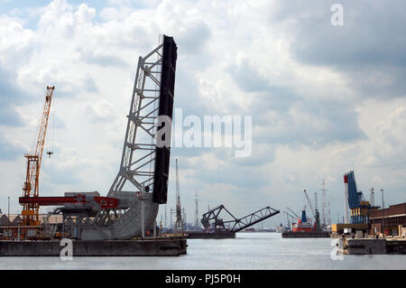 Two bridges open to allow large ships to enter Antwerp world harbor (all ship names, brands and logos have been removed) Stock Photo