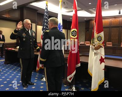 Gen. John M. Murray recites the commissioned officer oath of office during his promotion ceremony held at the newly appointed headquarters location for Army Futures Command in Austin, Texas, Aug. 24, 2018. U.S. Army Chief of Staff Gen. Mark A. Milley administered the oath and promoted Murray to the rank of four-star general on the same day as Army Futures Command’s activation ceremony. (U.S. Army photo Staff Sgt. B. Nicole Mejia/Released) Stock Photo