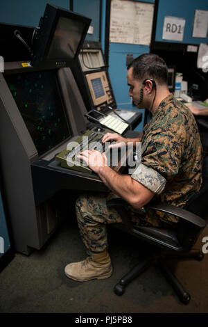 U.S. Marine Corps Cpl. Daniel Safirstein, air traffic controller, Headquarters & Headquarters Squadron, Marine Corps Air Station (MCAS) Camp Pendleton, provides a beacon code to a pilot while in position at the Radar Air Traffic Control Facility at MCAS Camp Pendleton, California, Aug. 24, 2018. Safirstein is in charge of monitoring multiple aircraft across MCAS Camp Pendleton’s air space. (U.S. Marine Corps photo by Lance Cpl. Betzabeth Y. Galvan) Stock Photo