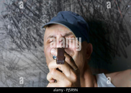 portraot of a shortsighted  man looking at the timepiece Stock Photo