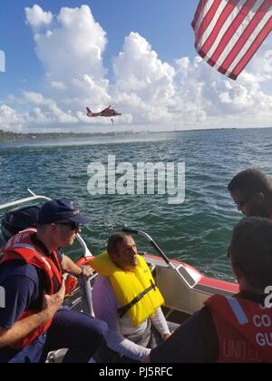 Robert Vonnegut sits aboard a Coast Guard Station Islamorada 33-foot Special Purpose Craft-Law Enforcement boat after being rescued by the crewmembers Aug. 27, 2018 near Tavernier, Florida. The boatcrew and a Coast Guard Air Station Miami MH-65 helicopter crew went searching for Vonnegut after watchstanders at Coast Guard Sector Key West received a report from the son of Vonnegut stating his father departed from Sunrise Drive and hadn't returned. (Coast Guard Photo) Stock Photo
