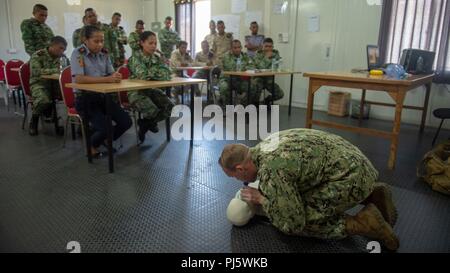 Hospital Corpsman 3rd Class Tom McCarthy, from McKinleyville, California, assigned to Naval Hospital Yokosuka, performs CPR on a training dummy during CARAT Timor-Leste 2018 at Hera Naval Base, Aug. 28, 2018. CARAT Timor-Leste 2018 is designed to address shared maritime security concerns, build relationships and enhance interoperability among participating forces. (U.S. Navy photo by Mass Communication Specialist 3rd Class Danny Ray Nuñez Jr./Released) Stock Photo