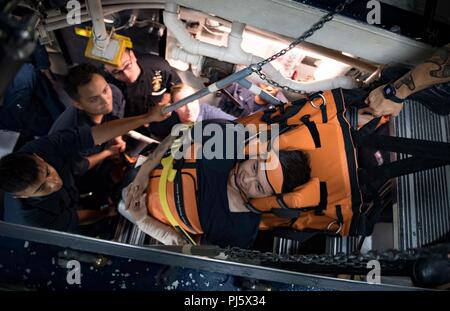 180828-N-UY653-135  MEDITERRANEAN SEA (Aug. 28, 2018) Sailors participate in stretcher bearer training aboard the Arleigh Burke-class guided-missile destroyer USS Carney (DDG 64) Aug. 28, 2018. Carney, forward-deployed to Rota, Spain, is on its fifth patrol in the U.S. 6th Fleet area of operations in support of regional allies and partners as well as U.S. national security interests in Europe and Africa. (U.S. Navy photo by Mass Communication Specialist 1st Class Ryan U. Kledzik/Released) Stock Photo