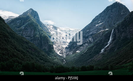 Epic mountain range with glacier in Briksdal Norway Stock Photo