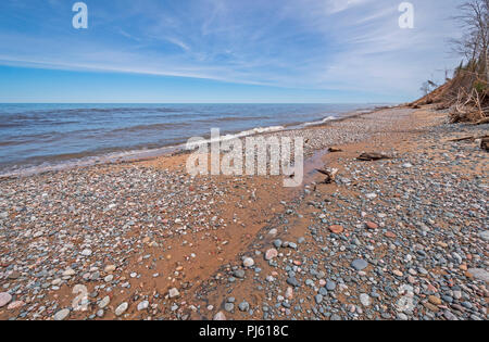 Cobblestones on a Sandy Beach in the Early Spring in Pictures Rocks National Lakeshore near Grand Marais,  Michigan on Lake Superior Stock Photo