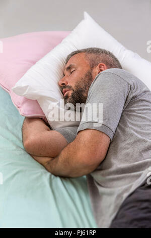 Happy to Sleep. Young Man Sleeping on his Bed With Eyes Closed Stock Photo