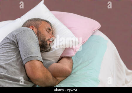 Happy to Sleep. Young Man Sleeping on his Bed With Eyes Closed Stock Photo