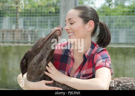 shelter keeper loves her residents Stock Photo