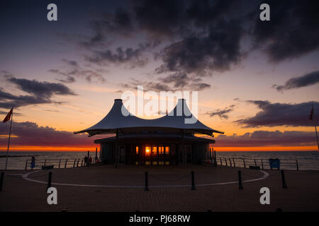 Aberystwyth Wales UK,  Tuesday 04 September 2018  UK Weather: Sunset shining through the windows of  Aberystwyth's distinctive    modern bandstand on the seafront promenade.  photo © Keith Morris / Alamy Live News Stock Photo